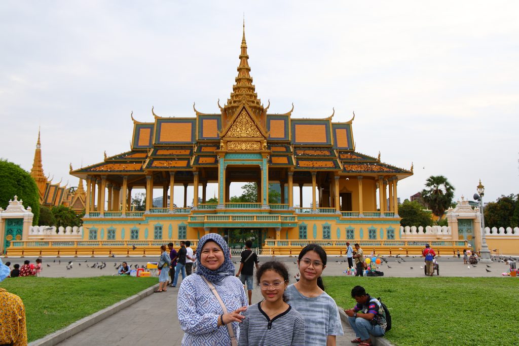 Wife and daughters in front of a golden pavilion at the Royal Palace in Phnom Penh